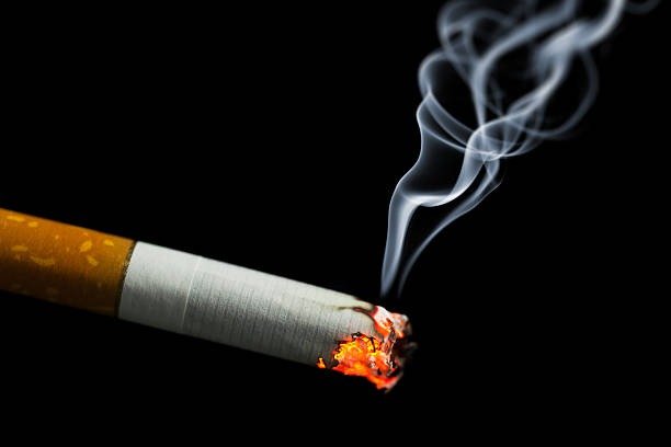 Burning cigarette with smoke illustrating tobacco regulation in Canada