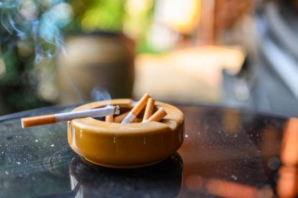 Burning cigarette in an ashtray