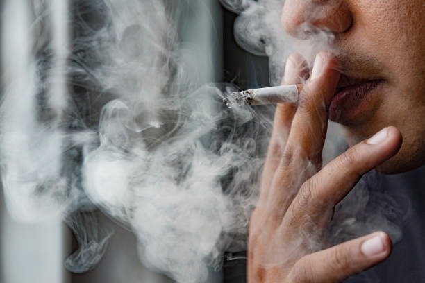 Man smoking a regular cigarette in Canada