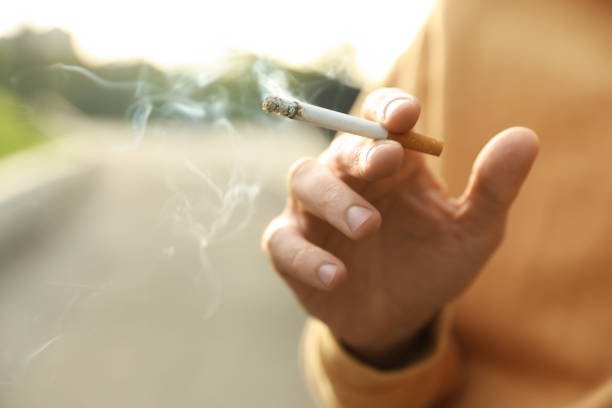 Man with cigarette outdoors closeup