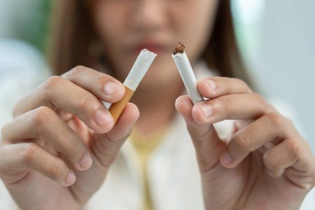 No smoking sign concept with a woman refusing a cigarette
