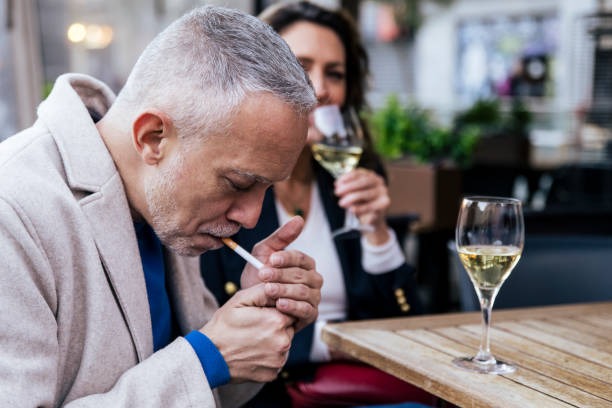 Middle-aged Canadian man smoking a cigarette on a terrace