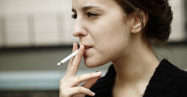 Person smoking a legally purchased cigarette outdoors