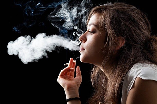Woman enjoying a menthol cigarette outdoors